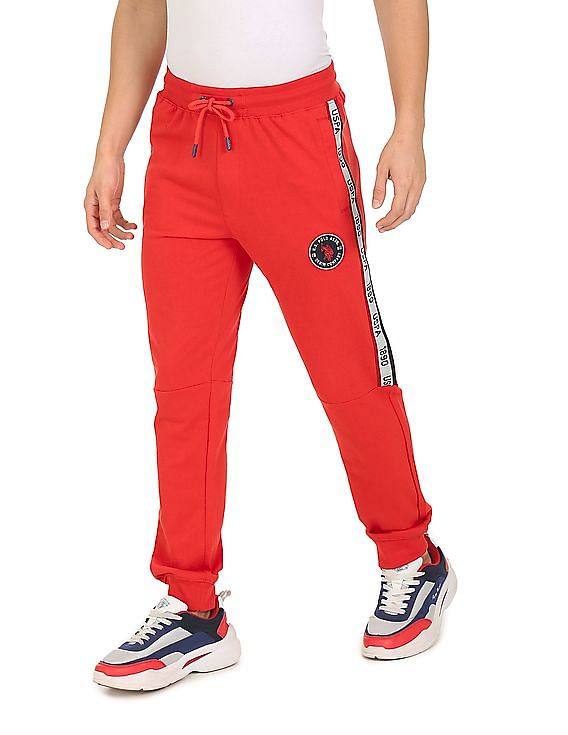 Red nike tape online joggers